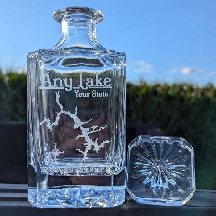 Lifestyle photo: engraved whiskey decanter with a sample lake design, outdoors on a sunny day